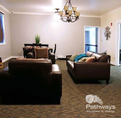 A cozy living room with couches and chairs, creating a comfortable environment for mental health care patients.