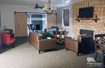A mental health care center with a living room featuring couches and a fireplace.