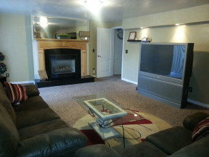 A rehab center living room with a tv and a fireplace.