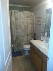 A drug rehab center in Utah with a sink and shower curtain facilities.