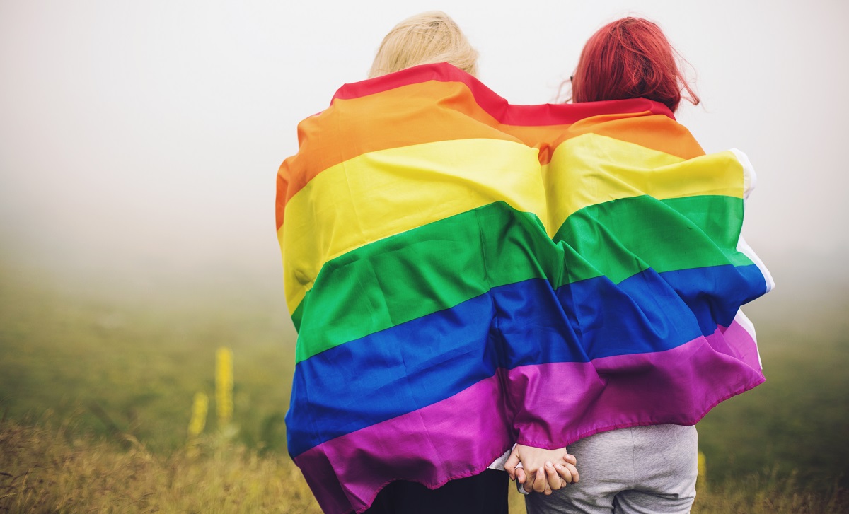 Couple with a LGBTQ+ Pride Flag